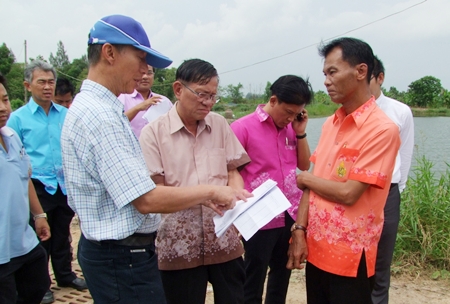Chonburi Gov. Khomsan Ekachai (front left) discusses flood prevention methods with local officials in Panthong and Phanasnikhom sub-districts.